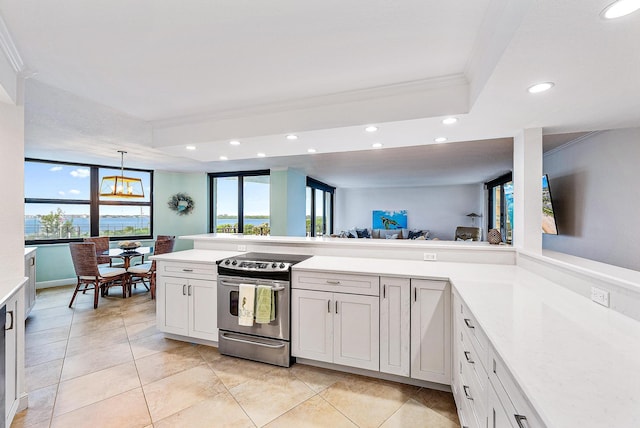 kitchen with decorative light fixtures, white cabinets, crown molding, a tray ceiling, and electric stove