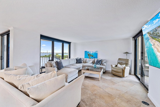 living room with floor to ceiling windows, light tile flooring, and a textured ceiling