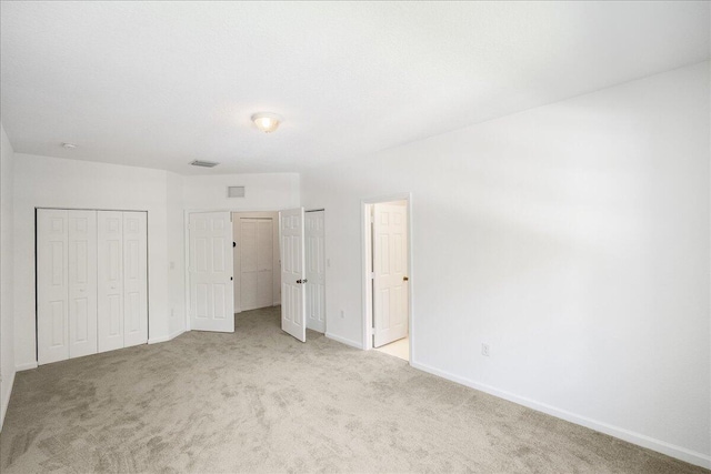 unfurnished bedroom with light colored carpet