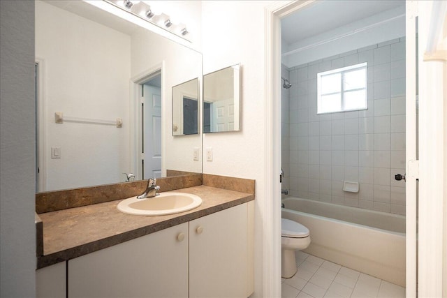 full bathroom featuring vanity with extensive cabinet space, toilet, tile flooring, and tiled shower / bath combo