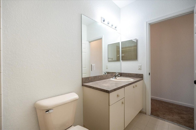 bathroom featuring tile floors, oversized vanity, and toilet