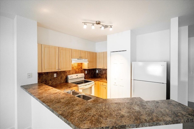 kitchen with white appliances, light brown cabinets, backsplash, kitchen peninsula, and rail lighting