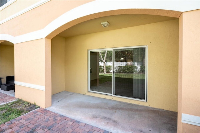 doorway to property with a patio area