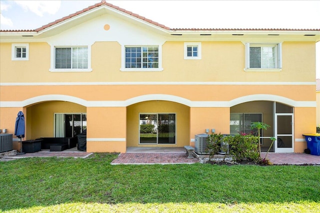 back of property with a patio, central AC, an outdoor hangout area, and a lawn