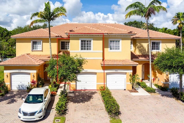 mediterranean / spanish house with a garage