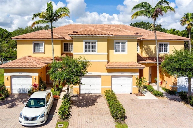 mediterranean / spanish house featuring a garage