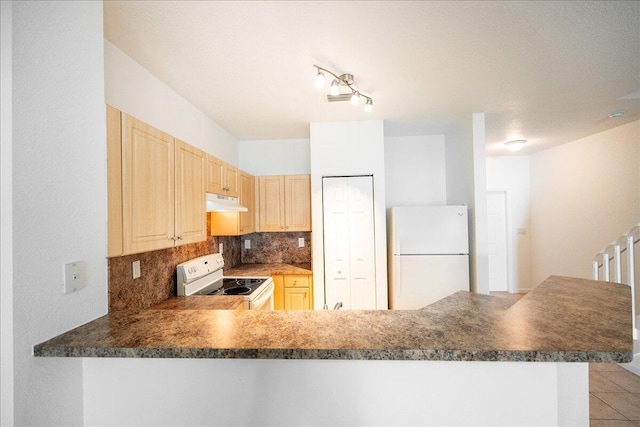 kitchen with white appliances, kitchen peninsula, backsplash, and light brown cabinets