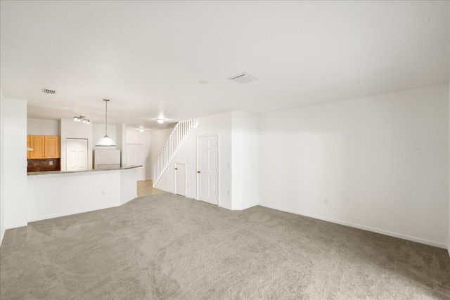 unfurnished living room featuring carpet floors