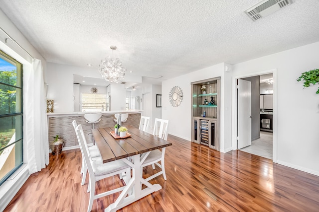 kitchen with sink, appliances with stainless steel finishes, kitchen peninsula, and white cabinetry