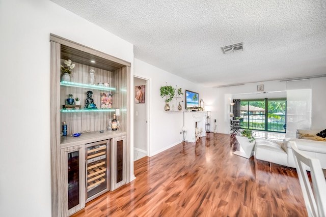 kitchen featuring stainless steel fridge with ice dispenser, light tile floors, and white cabinets