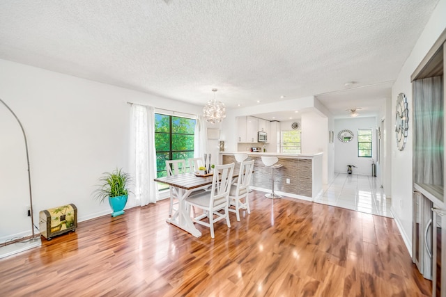 kitchen with sink, appliances with stainless steel finishes, white cabinetry, and light tile floors