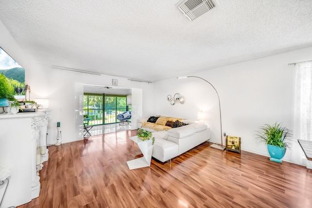 dining room with hardwood / wood-style flooring and a textured ceiling