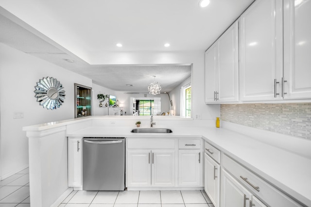 kitchen featuring white cabinets, backsplash, stainless steel appliances, light tile floors, and sink