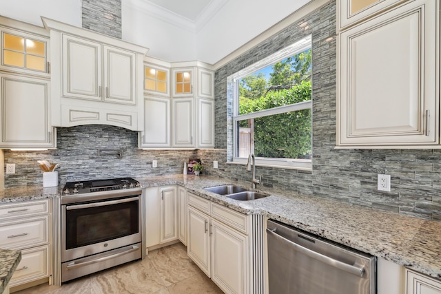 kitchen with light stone countertops, stainless steel appliances, and sink