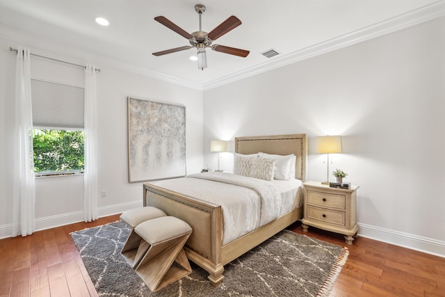 bedroom featuring ceiling fan, wood-type flooring, and crown molding