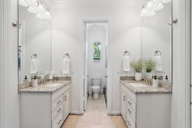 bathroom featuring tile patterned flooring, vanity, toilet, and crown molding