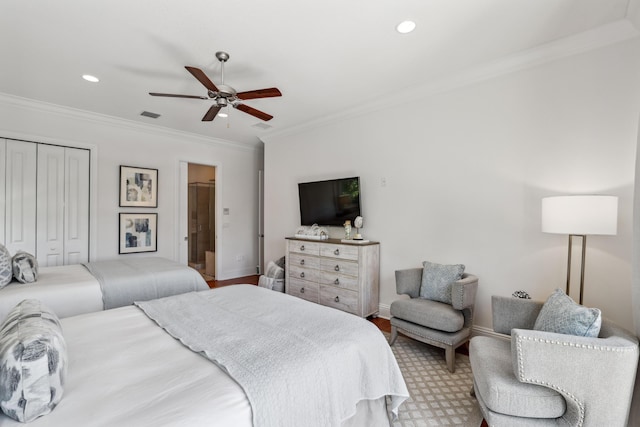 bedroom with ceiling fan, a closet, and crown molding