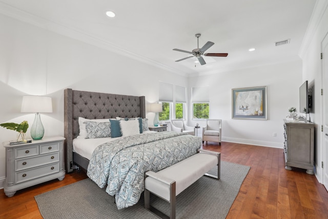 bedroom featuring ceiling fan, dark hardwood / wood-style floors, and ornamental molding