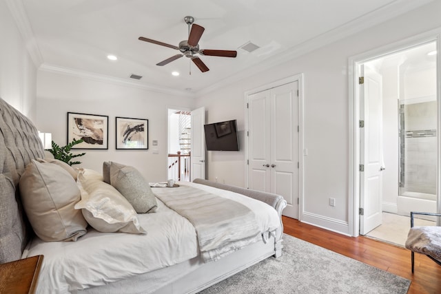 bedroom featuring ensuite bath, ceiling fan, crown molding, a closet, and hardwood / wood-style flooring