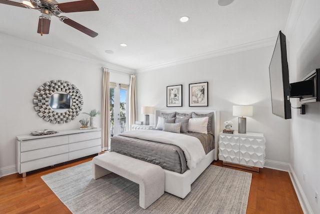 bedroom with ceiling fan, hardwood / wood-style floors, and ornamental molding