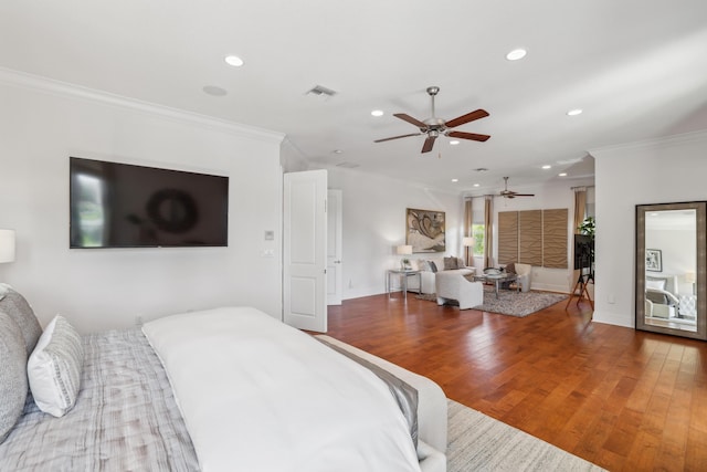 bedroom with crown molding, ceiling fan, and hardwood / wood-style flooring