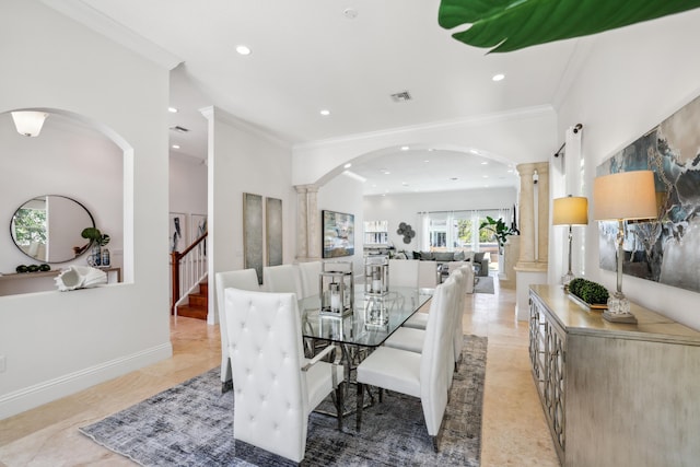 dining space featuring light tile patterned floors, crown molding, and decorative columns