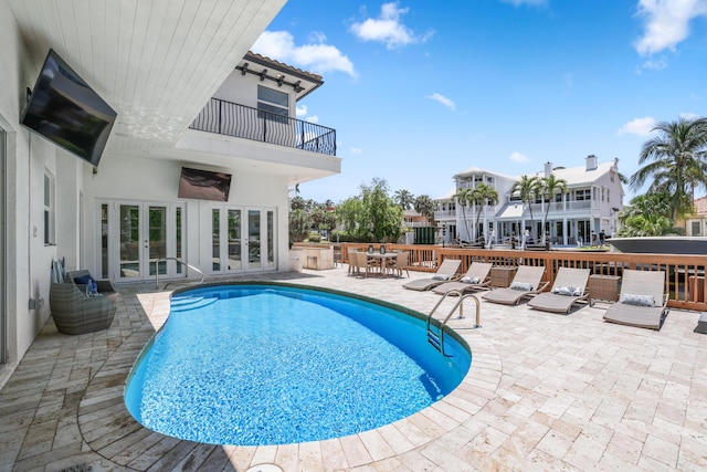 view of pool featuring french doors and a patio area