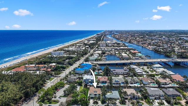 bird's eye view featuring a water view and a beach view