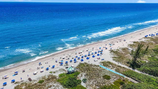 birds eye view of property featuring a view of the beach and a water view