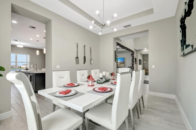 dining area featuring sink and a chandelier