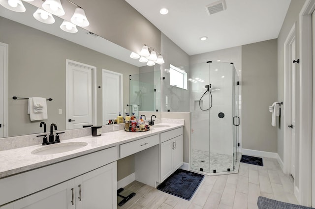 bathroom featuring walk in shower and vanity