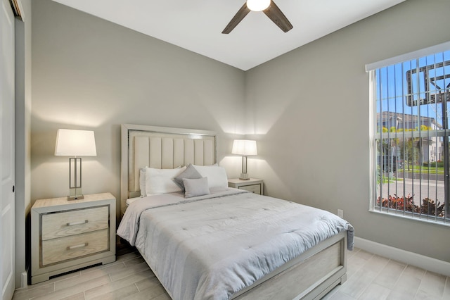 bedroom with light hardwood / wood-style flooring, ceiling fan, and a closet