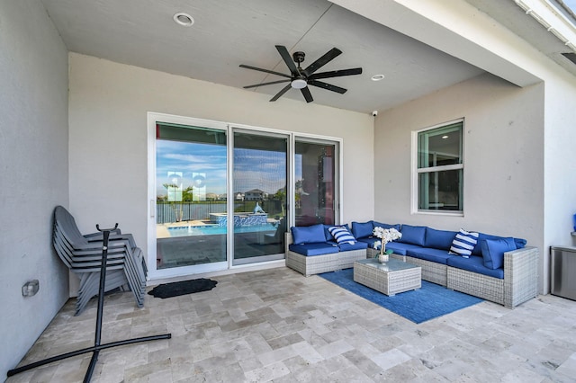 view of patio with an outdoor living space and ceiling fan