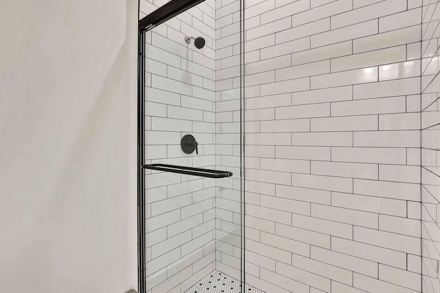 bathroom with a shower with door