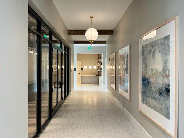 hall with french doors and beam ceiling