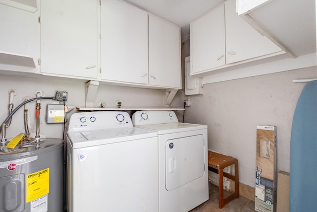 laundry room with cabinets, electric water heater, washer and dryer, and tile flooring