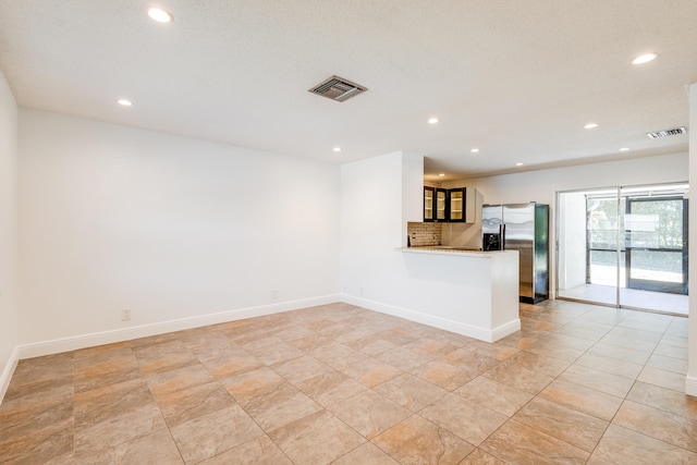 unfurnished living room with light tile floors