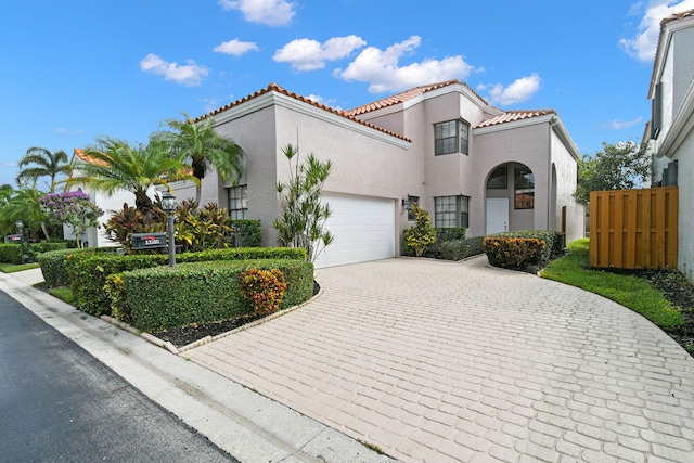 mediterranean / spanish house with a garage