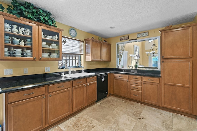 kitchen featuring black dishwasher, dark stone counters, sink, and a textured ceiling