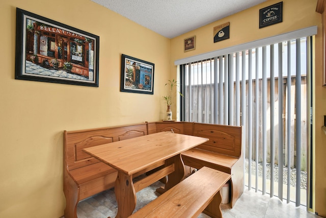 dining area featuring a textured ceiling