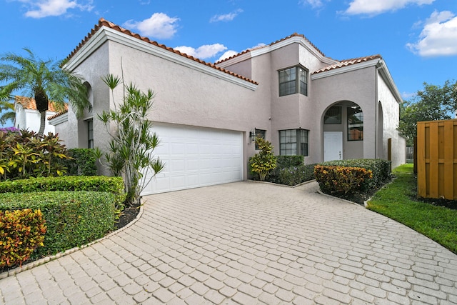 mediterranean / spanish house with a garage