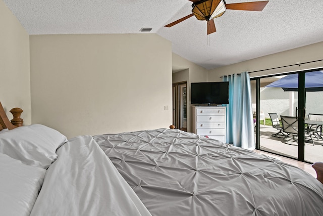 bedroom featuring ceiling fan, a textured ceiling, lofted ceiling, and access to exterior