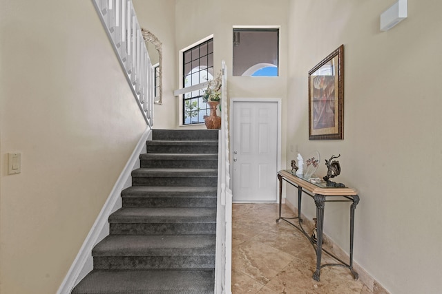 entryway featuring a towering ceiling