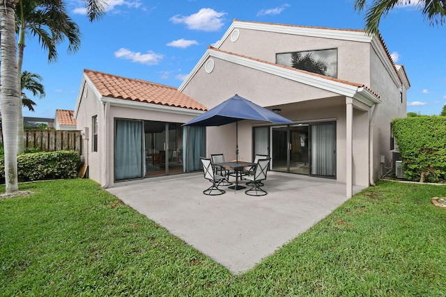 back of house featuring a patio and a yard