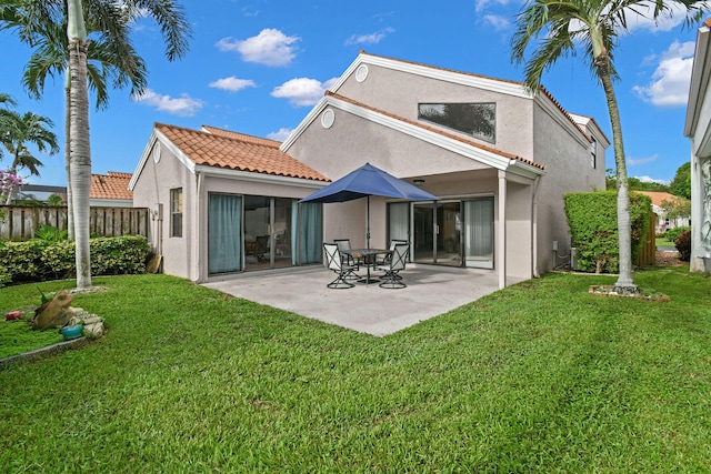 back of house featuring a yard and a patio area