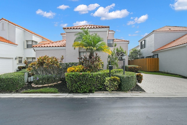 mediterranean / spanish house with a garage