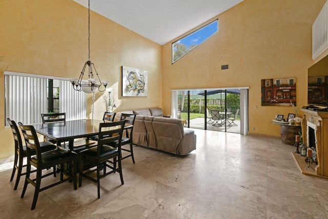 dining space with an inviting chandelier and a towering ceiling