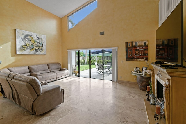 living room with a skylight and high vaulted ceiling