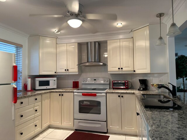 kitchen with ornamental molding, white appliances, wall chimney exhaust hood, sink, and light tile floors