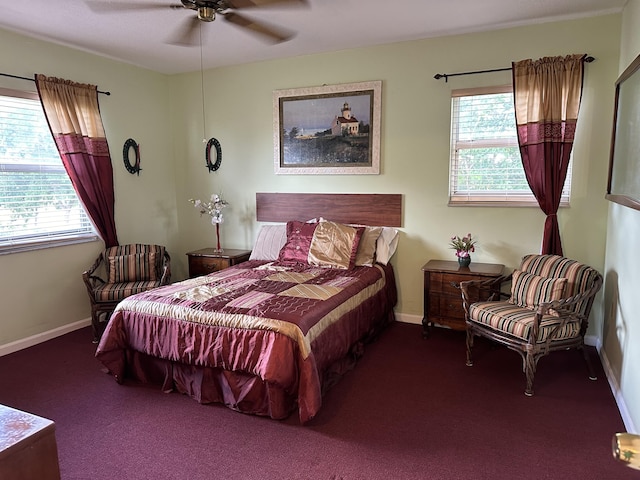 bedroom featuring multiple windows, ceiling fan, and dark colored carpet